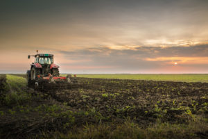 Traktori kyntää pellolla